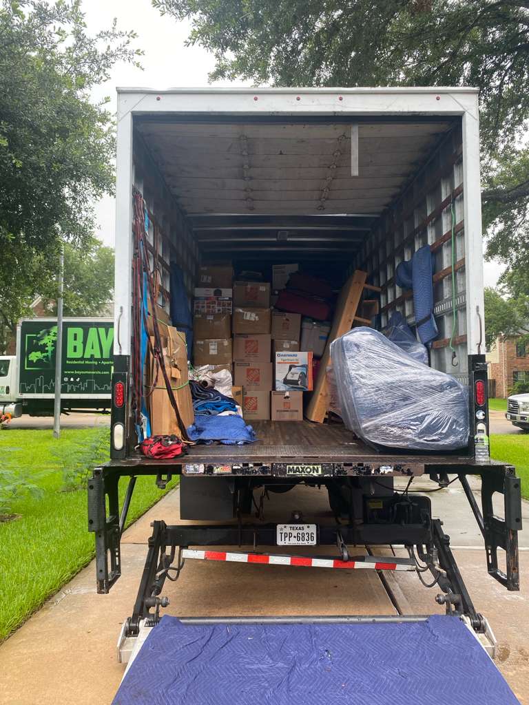 Bayou Movers truck loaded with boxes and wrapped furniture