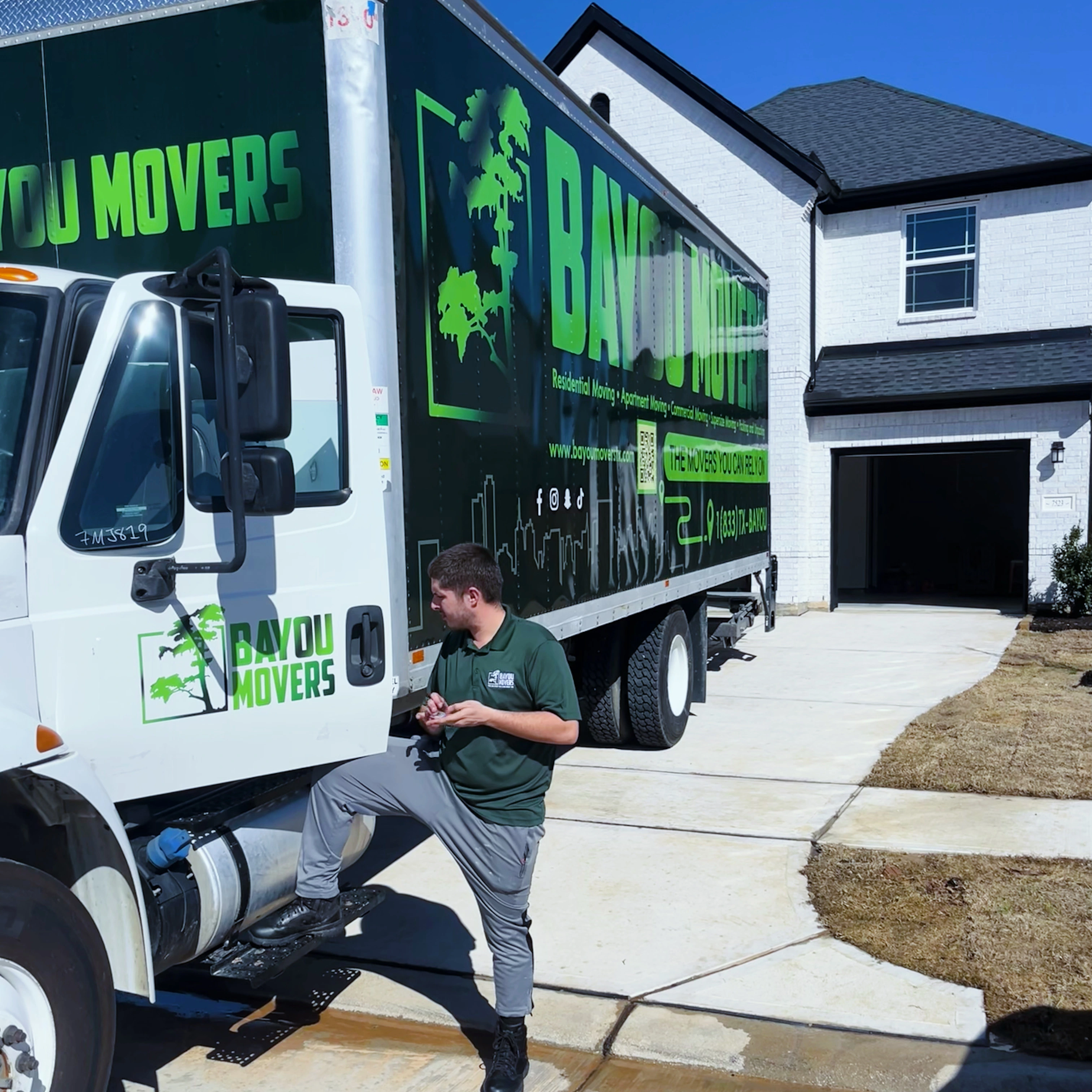 Bayou Movers crew member preparing beside the moving truck