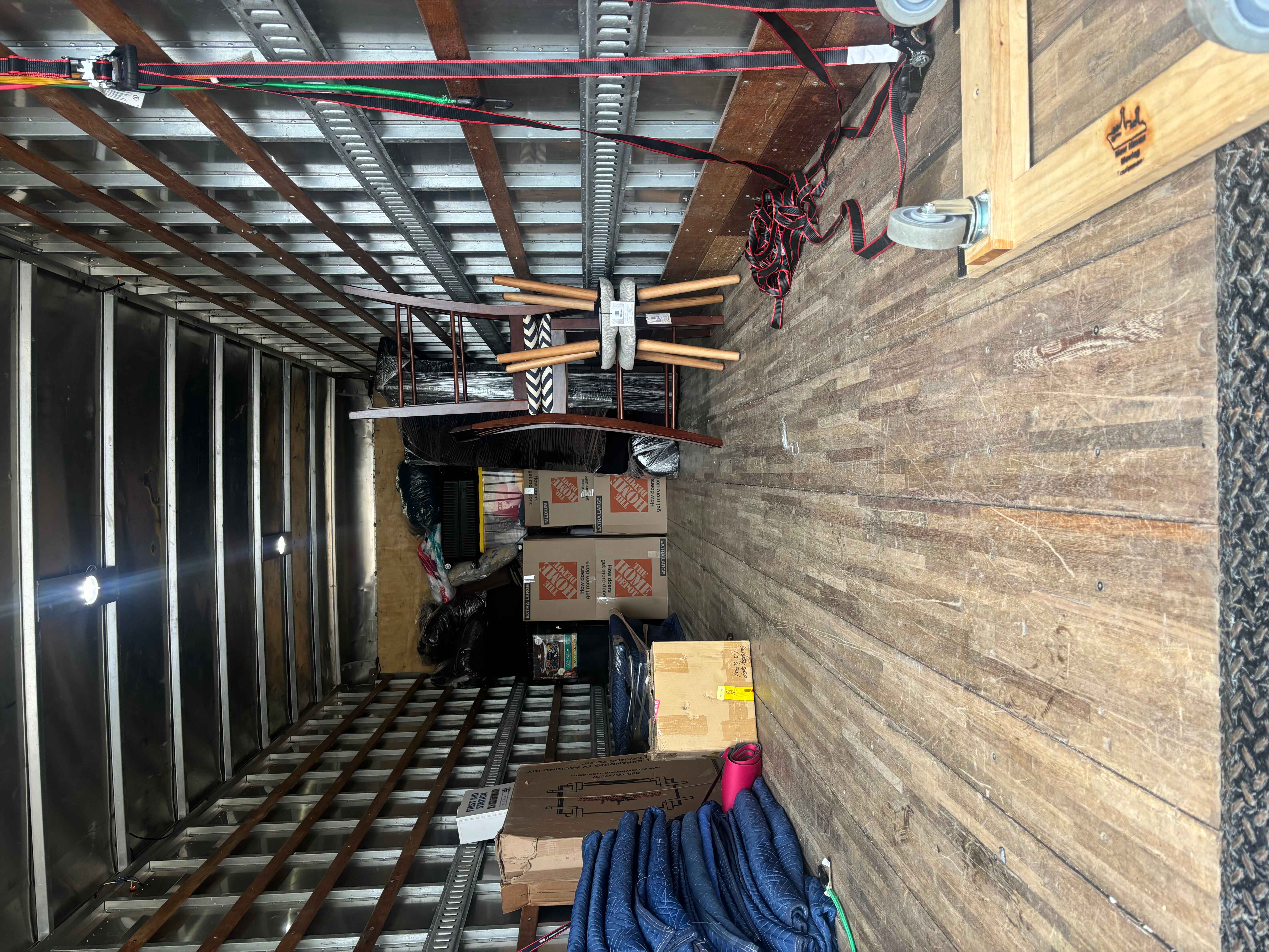 Organized interior of a Bayou Movers truck with blankets and boxes