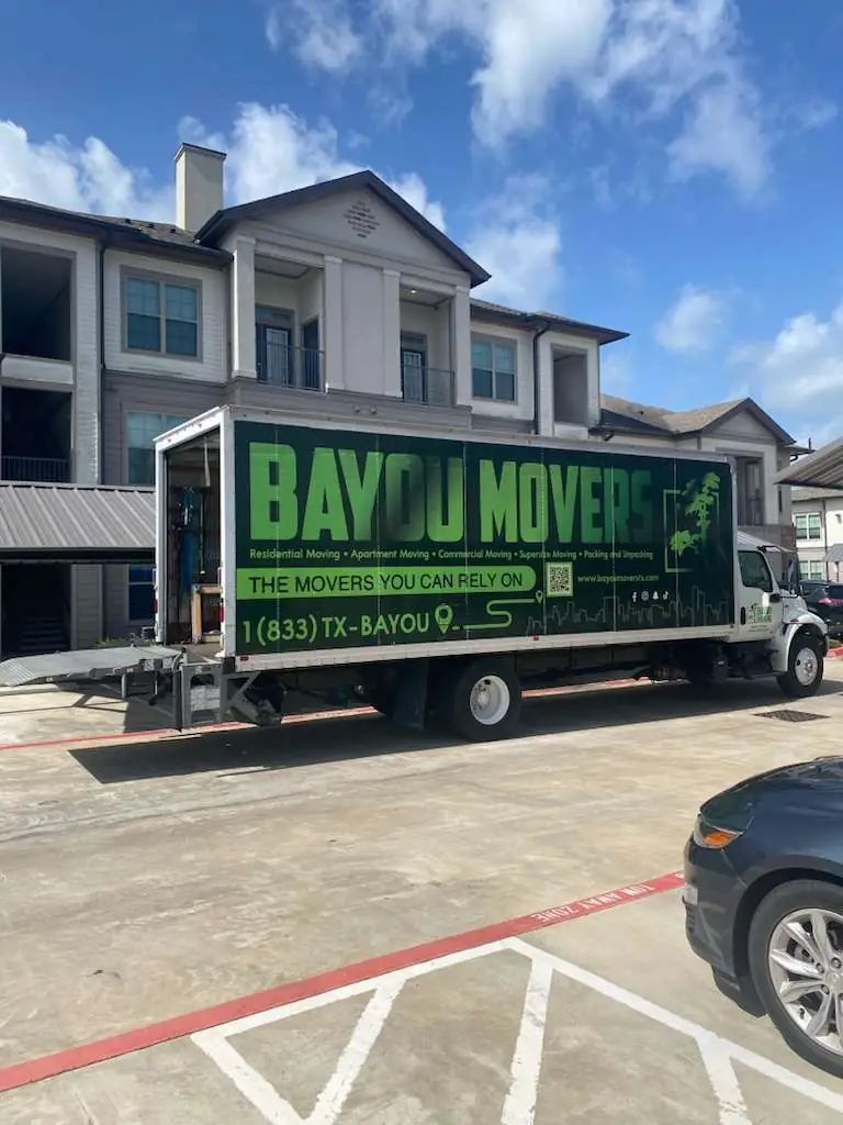Bayou Movers apartment moving truck parked outside a Houston apartment building